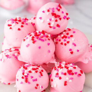 valentine oreo truffles stacked on a plate.