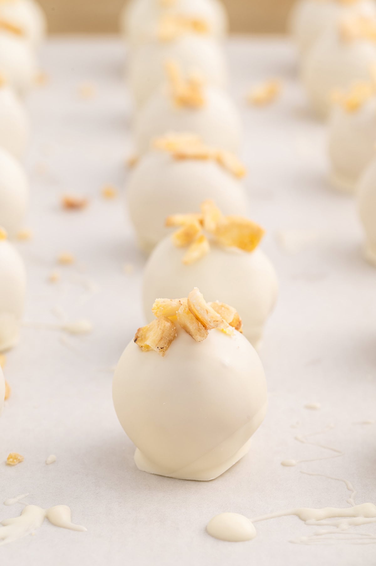 a couple of banana pudding truffles on top of parchment paper. 