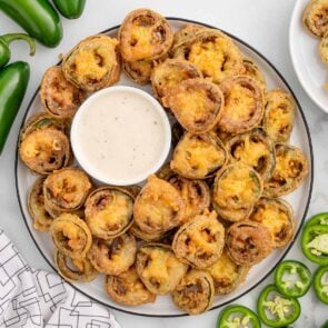 Fried jalapeño slices with dipping sauce.