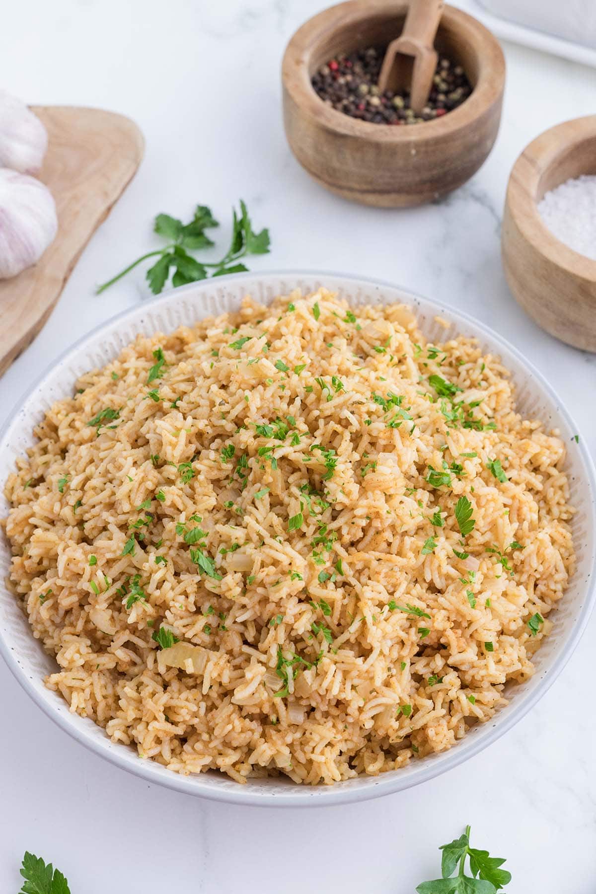 Bowl of seasoned rice with parsley garnish.