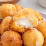 deep fried marshmallows stacked on a plate.