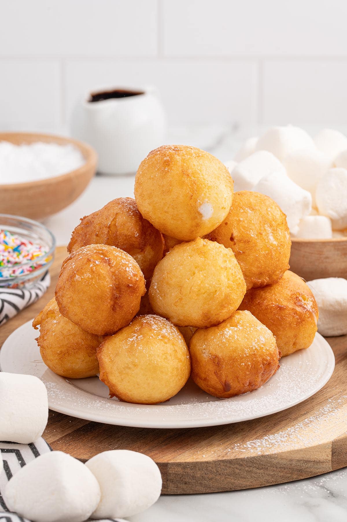 a couple of deep fried marshmallows stacked on a plate. 