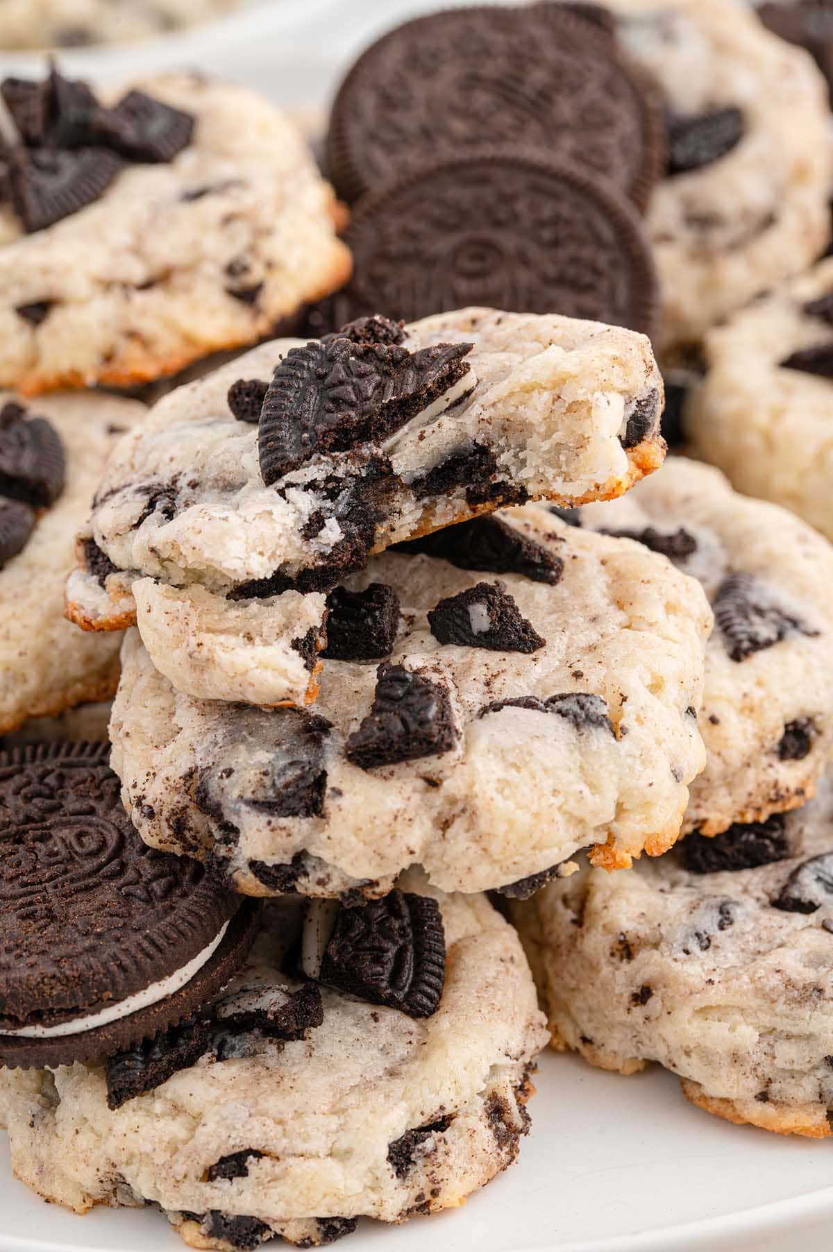 A close-up of bitten Oreo Cheesecake Cookies, showing a soft and creamy texture.