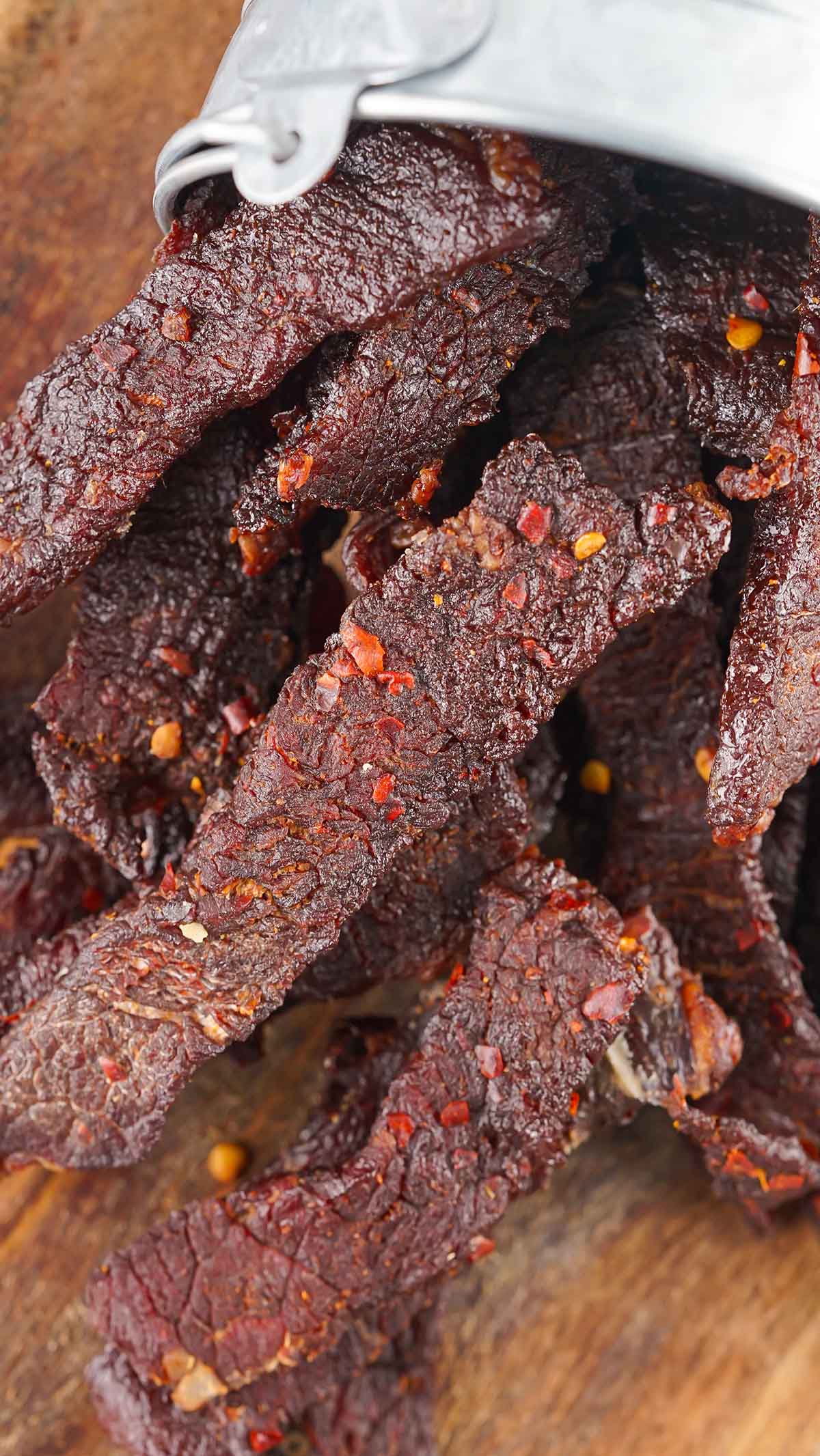 Smoked Beef Jerky on top of wooden board. 