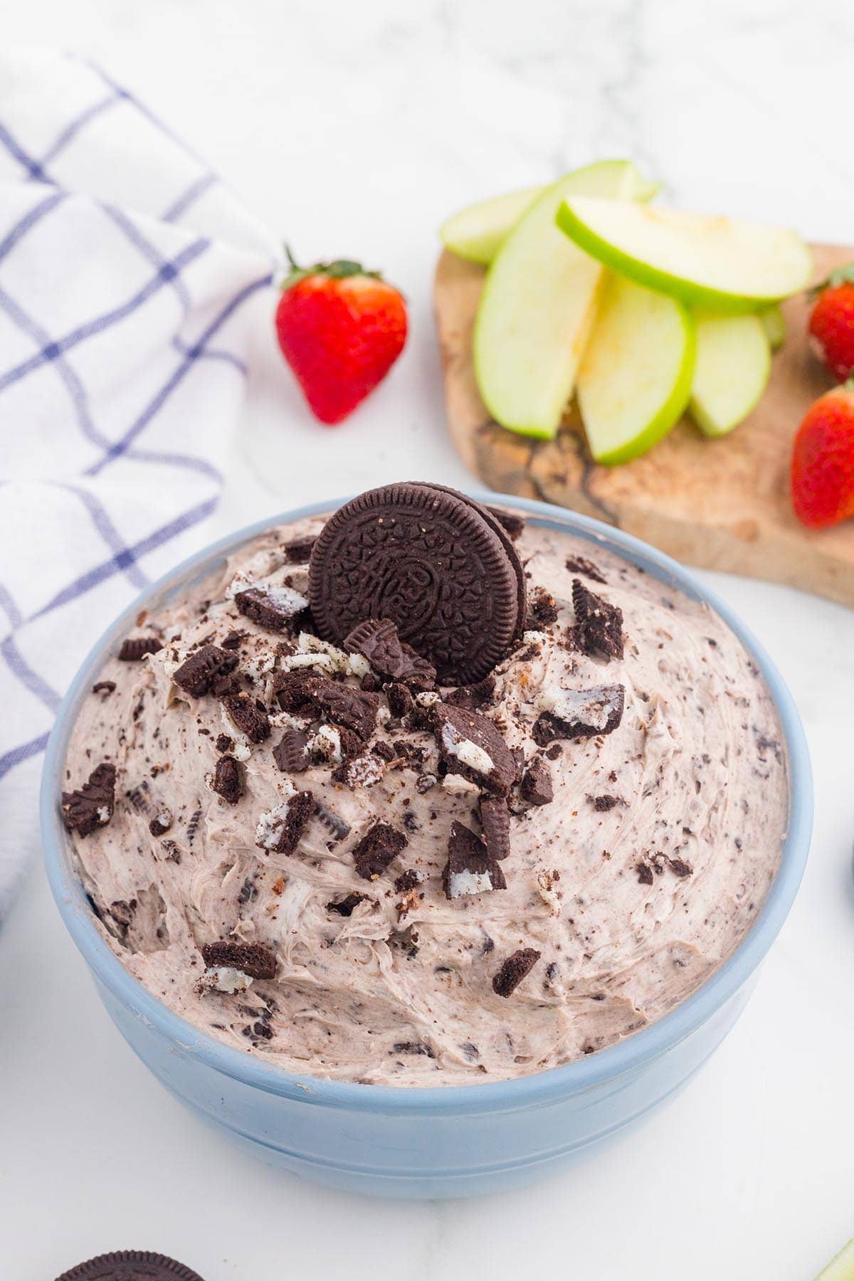 Oreo Dip with crushed cookies in a blue bowl.