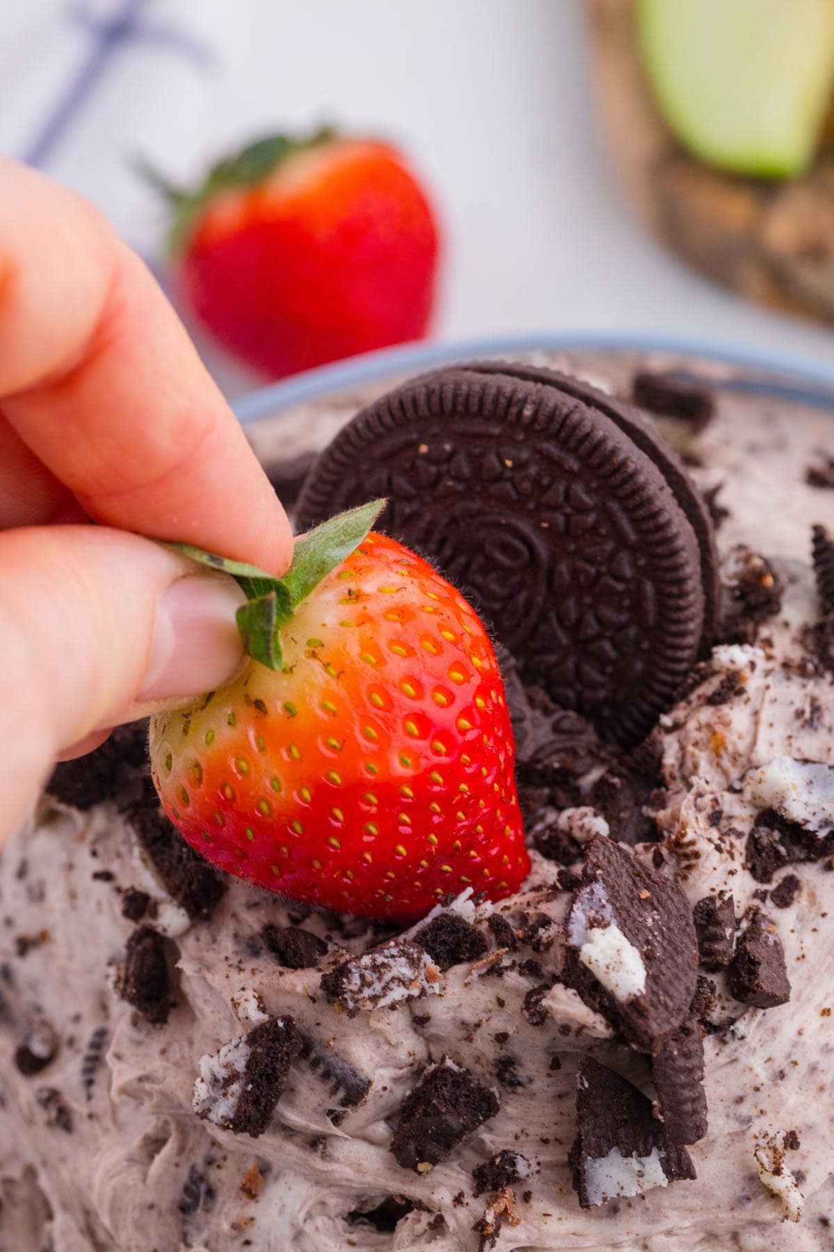 Dipping a strawberry into Oreo Dip.