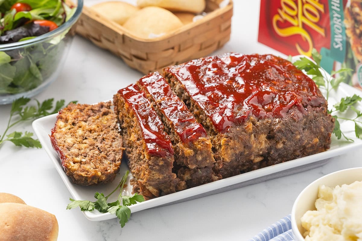 Stove Top Stuffing Meatloaf with ketchup glaze, sliced on a platter.