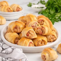 Plate of Sausage Cream Cheese Crescent Rolls with golden, flaky pastry.