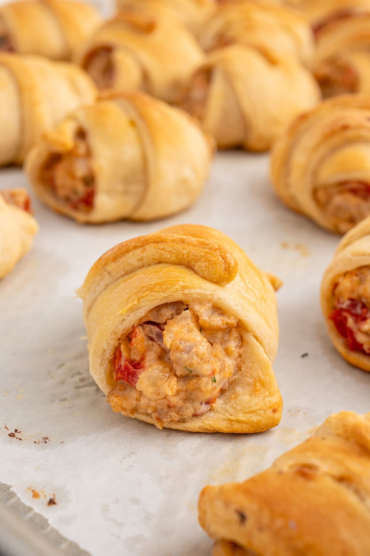 rotel sausage and cream cheese crescent on top of parchment paper. 