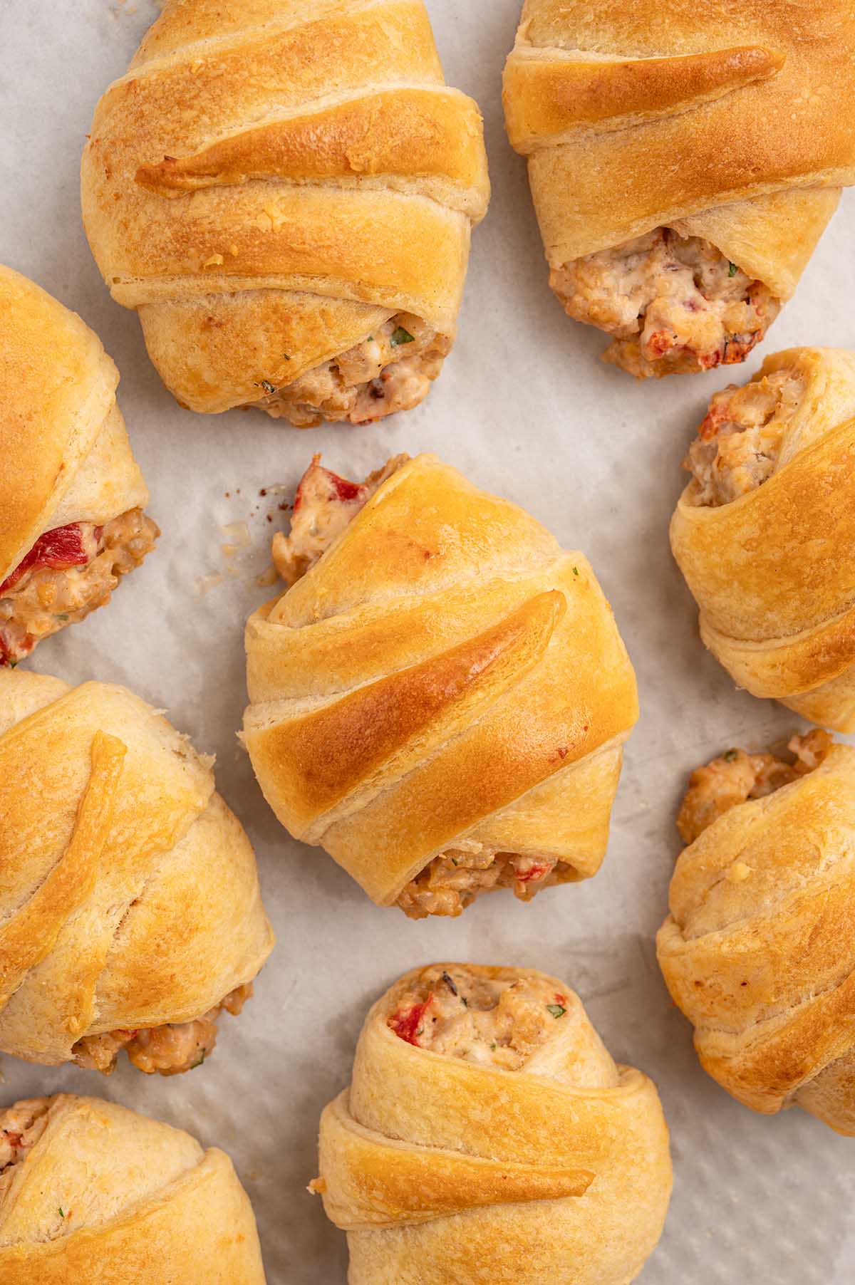 Sausage Cream Cheese Crescent Rolls on parchment paper.