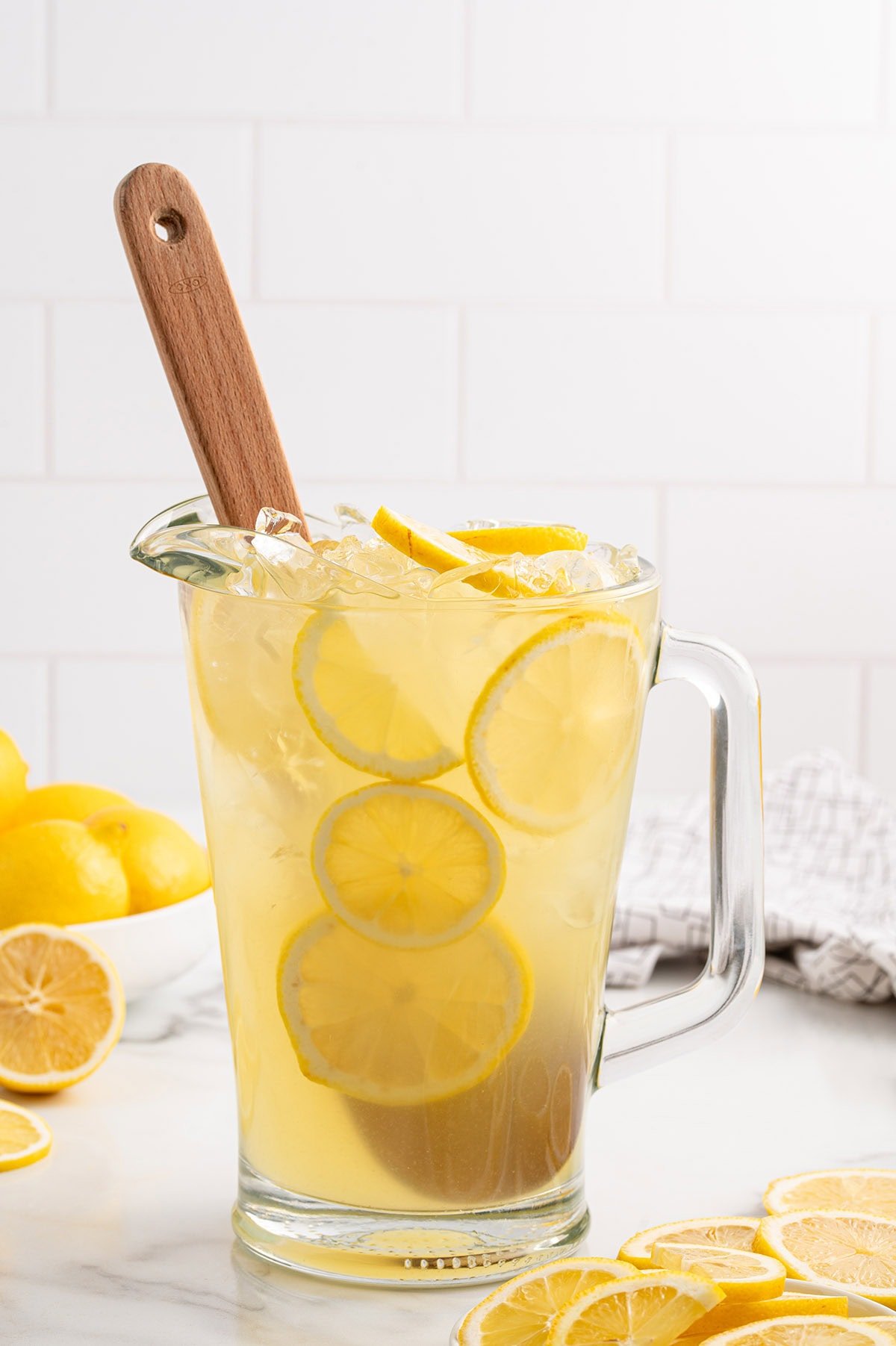 Pitcher of State Fair Lemonade with lemon slices and ice.