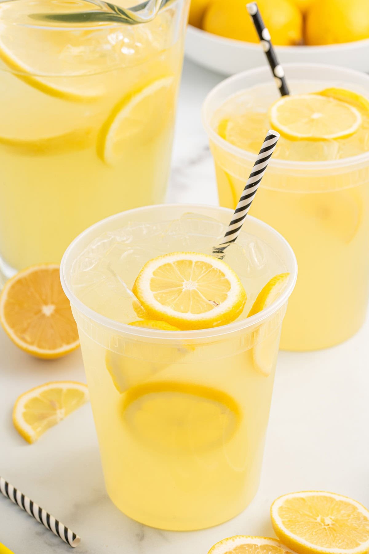 State Fair Lemonade with lemon slices, ice, and striped straws.