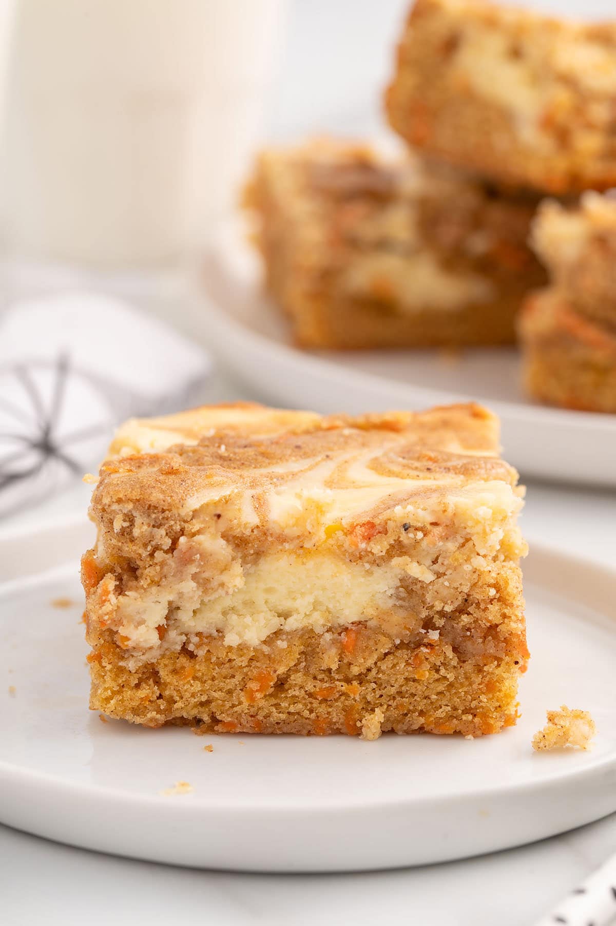 a slice of carrot cake bars on a plate. 