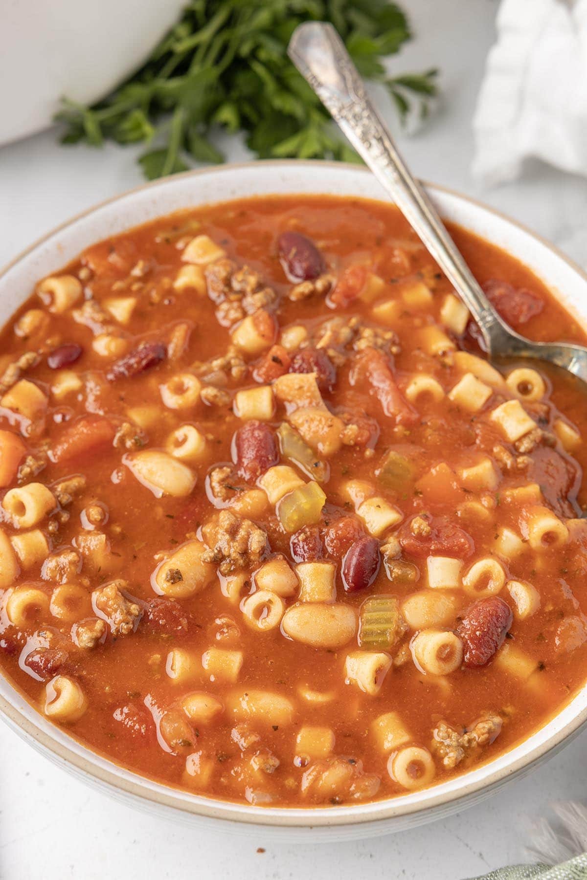 pasta e fagioli served in a white bowl. 