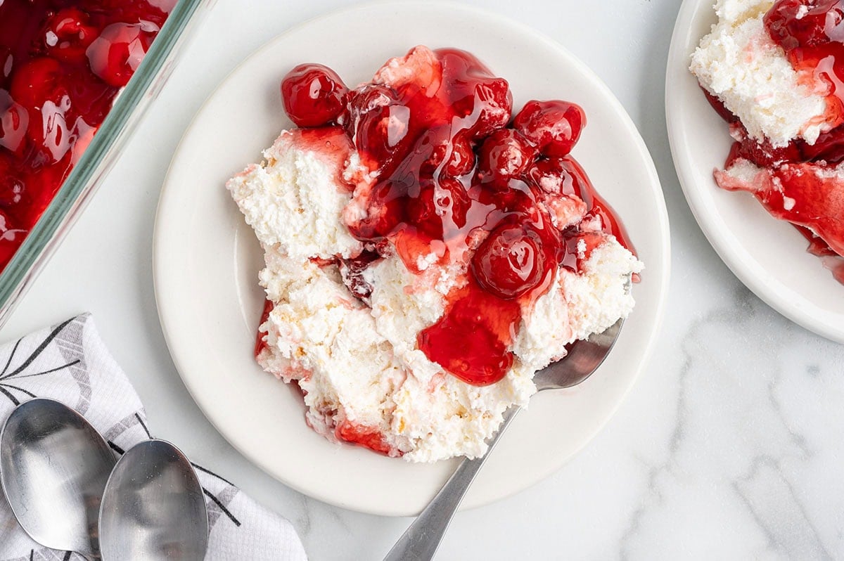 single serving of cherries in the snow on a plate.