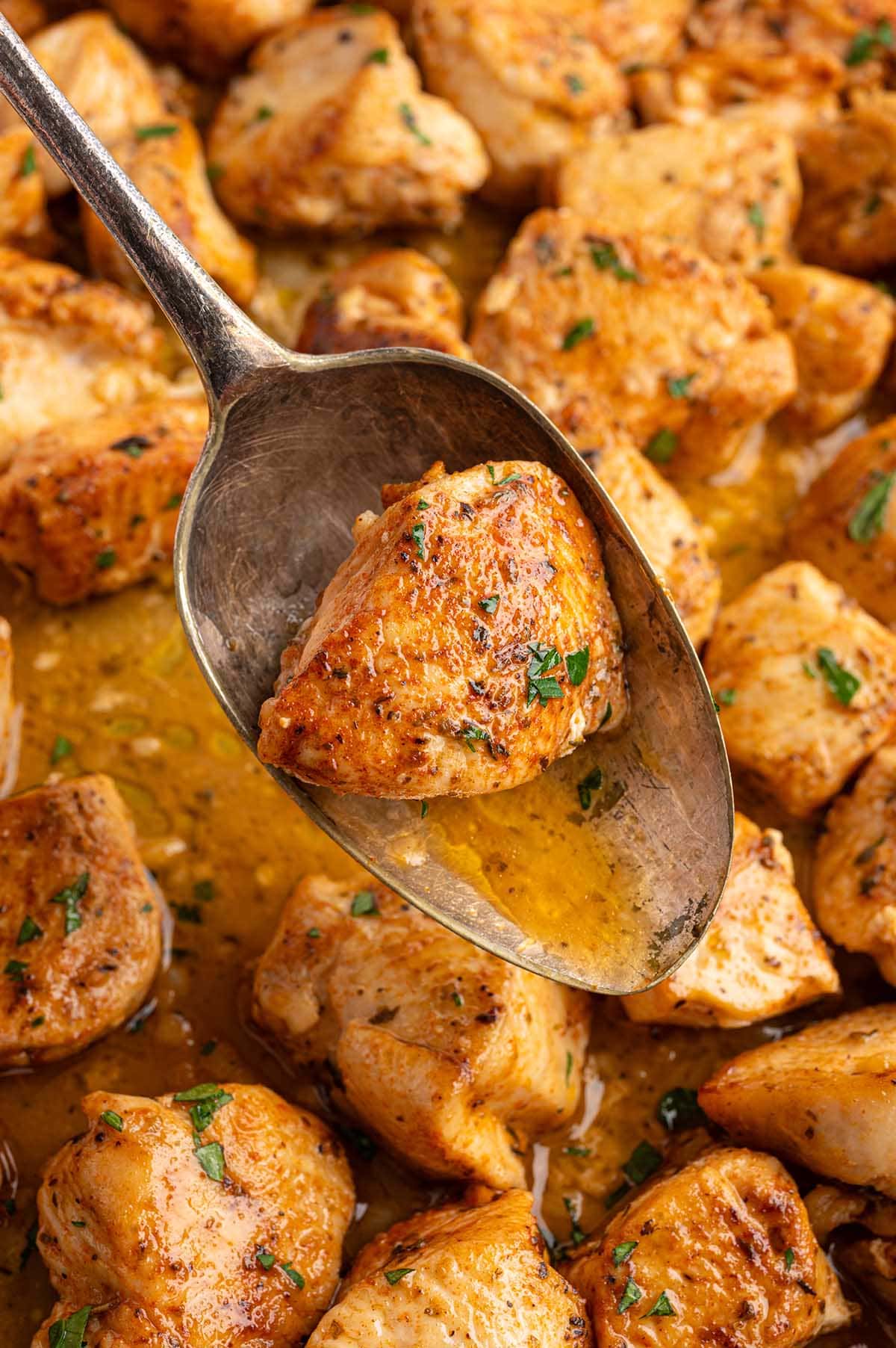 close up of juicy golden garlic butter chicken bites