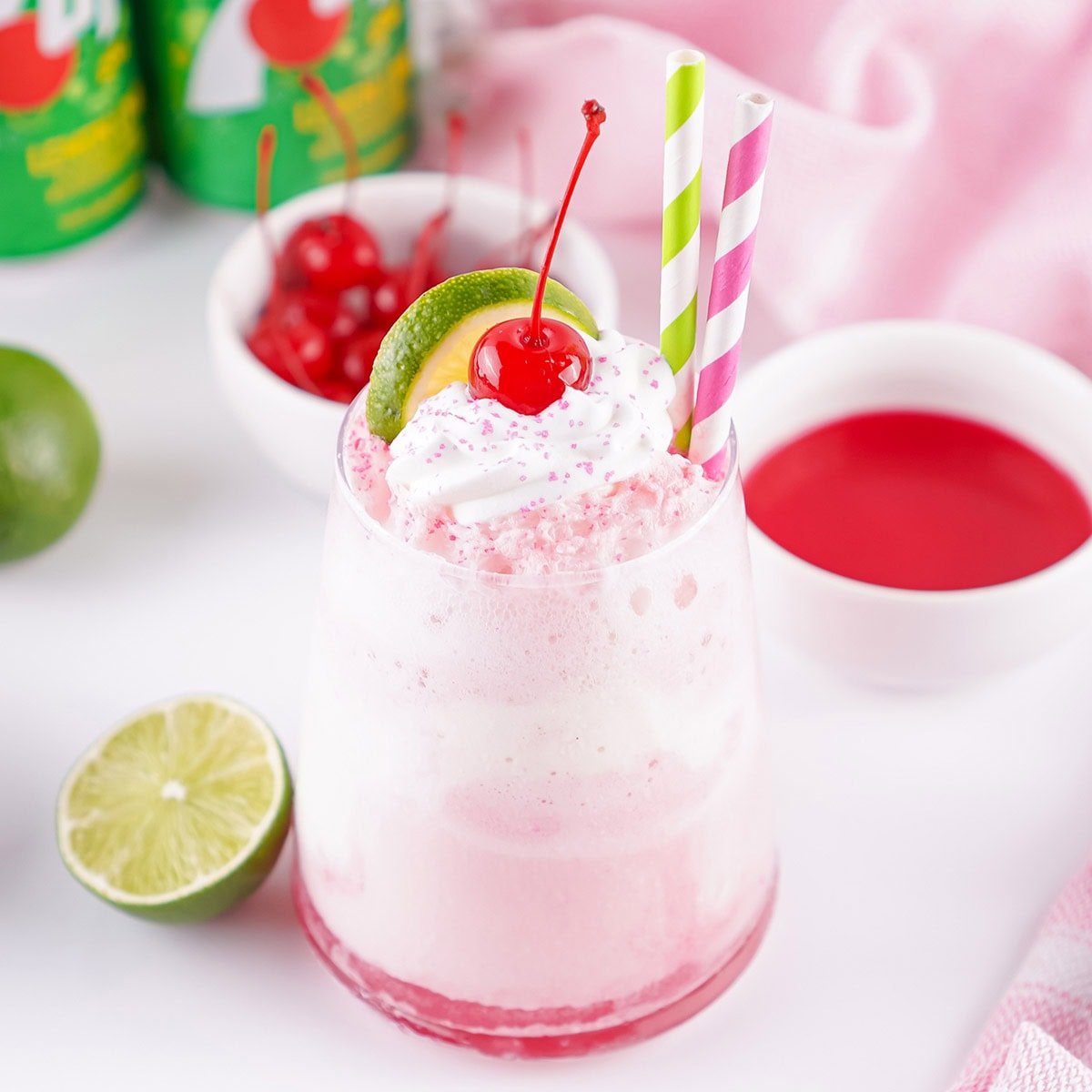 Shirley temple drink with whipped cream and cherry.