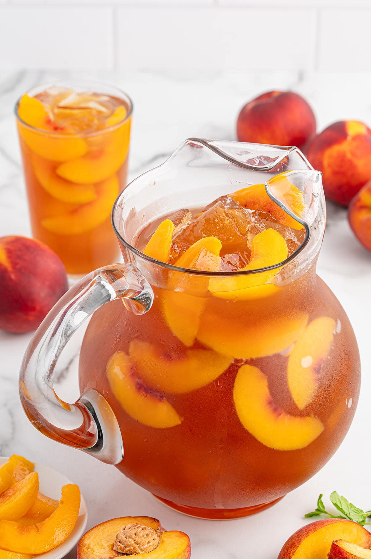 peach iced tea in a pitcher.