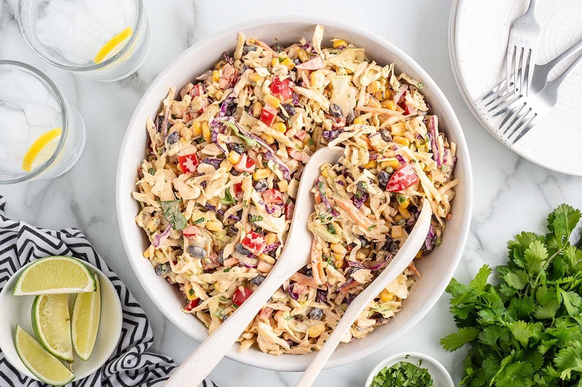 Freshly made coleslaw with corn, black beans, red peppers, and cabbage.