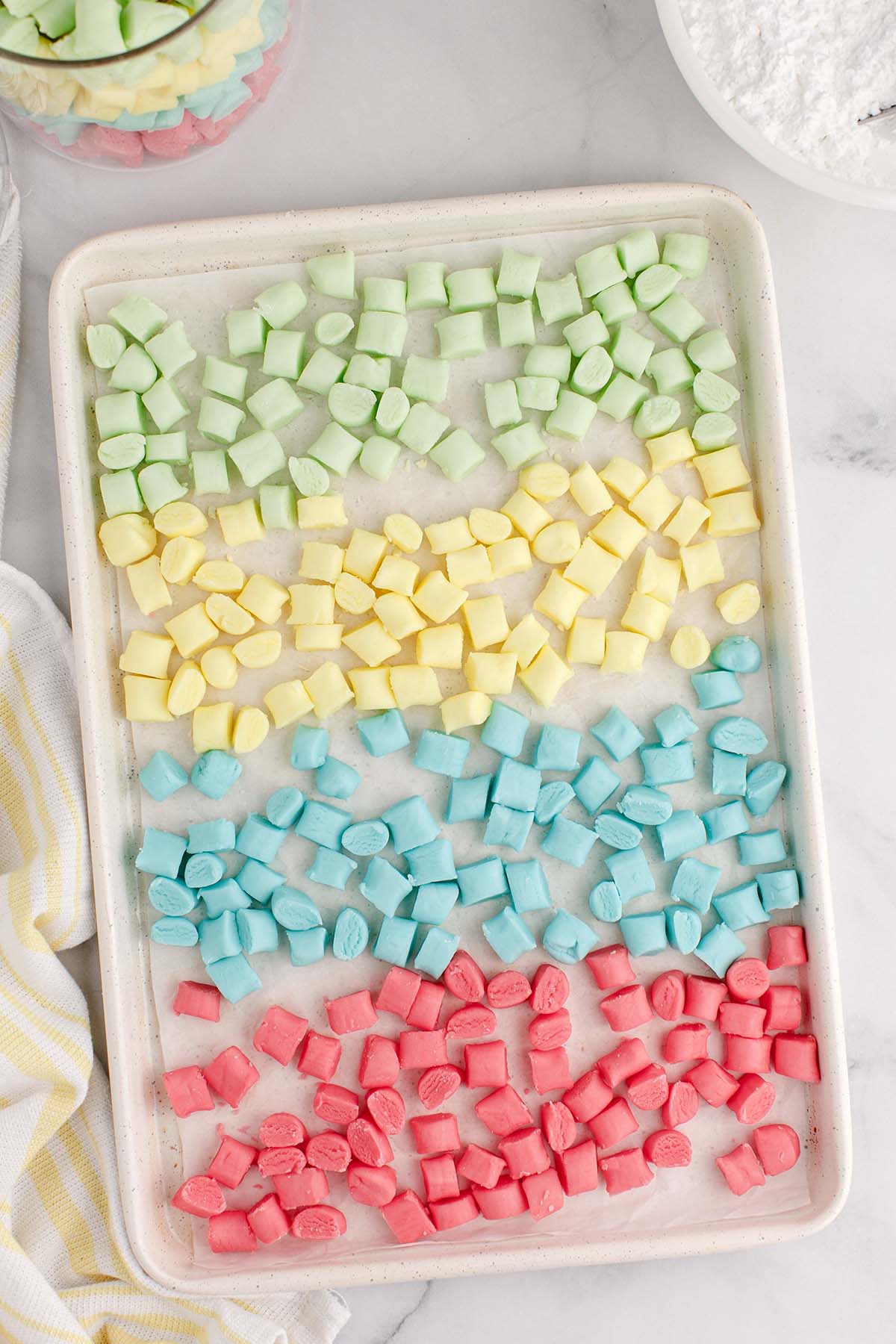 Pastel colored Butter Mints scattered on a serving tray