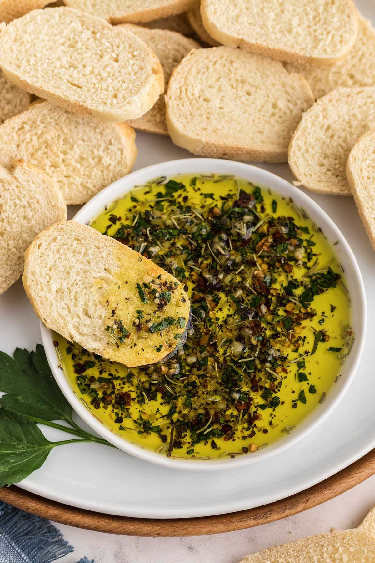 Slices of bread ready to dip in a bowl of seasoned olive oil.