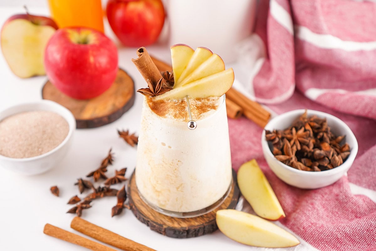 Fresh apple wedges add color to a creamy cider float garnished with cinnamon and star anise.
