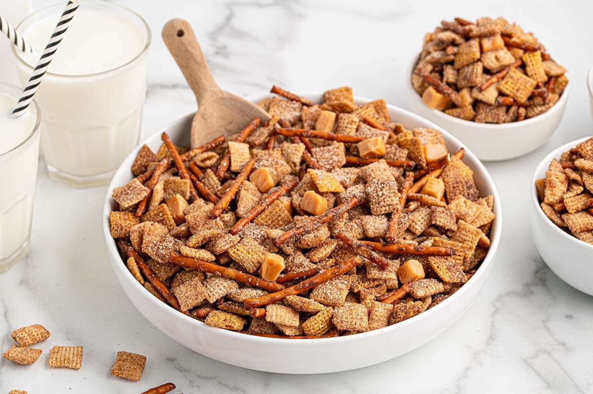 A large bowl of churro Chex mix with pretzel sticks and caramel chunks.