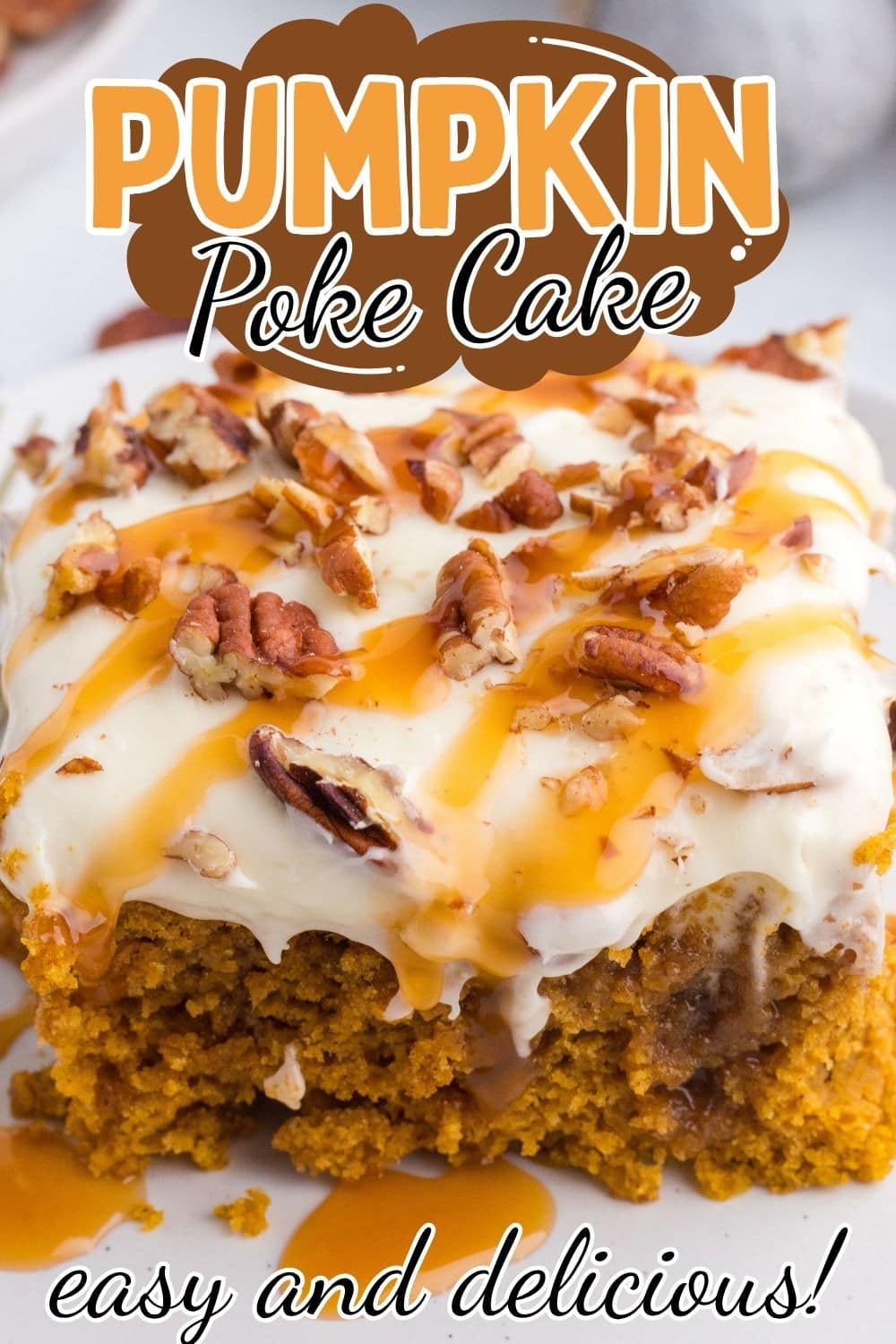 Close up of Square shaped pumpkin poke cake drizzled with caramel sauce and topped with chopped pecans served on a white plate