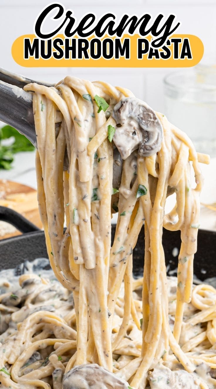 A tong grabbing Creamy Mushroom Pasta from the skillet