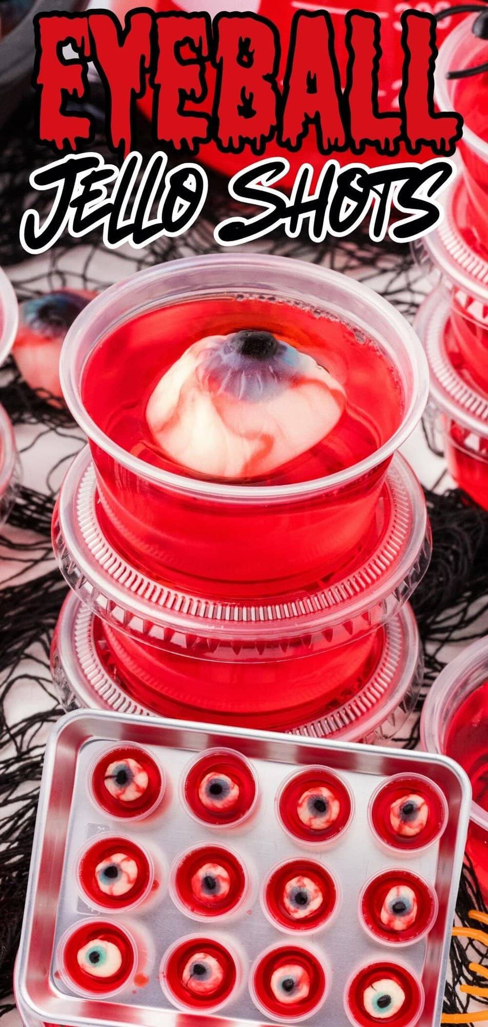 3 cups of eyeball jello shots stacks on top of each other. A dozen cups of eyeball jello shots lined on a silver tray