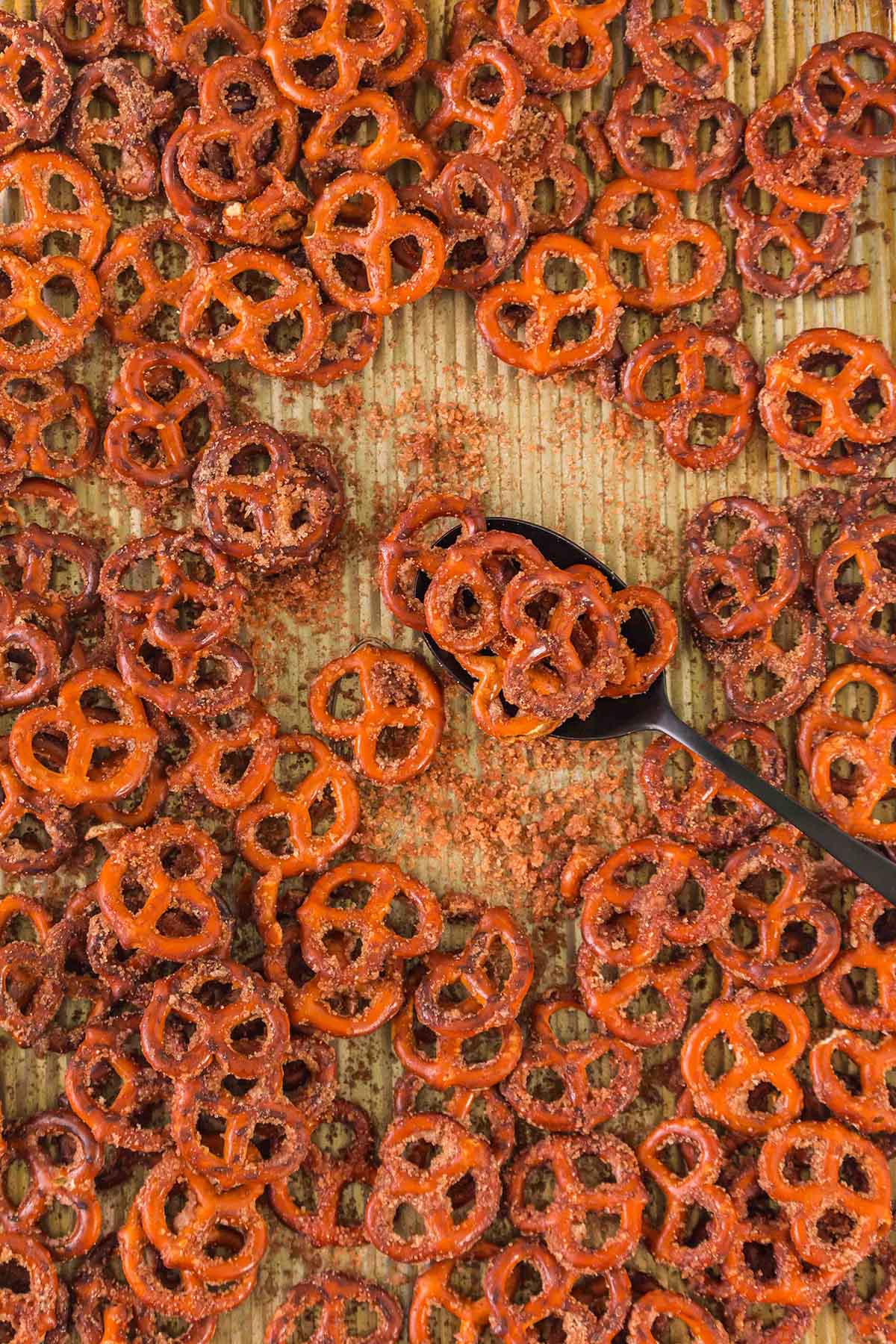 Small pretzels coated in cinnamon sugar, spread over a baking sheet.