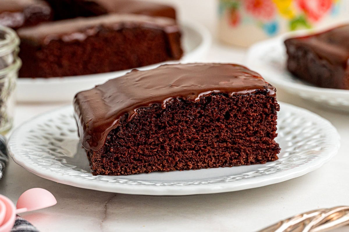 A slice of moist chocolate depression cake on a white plate.