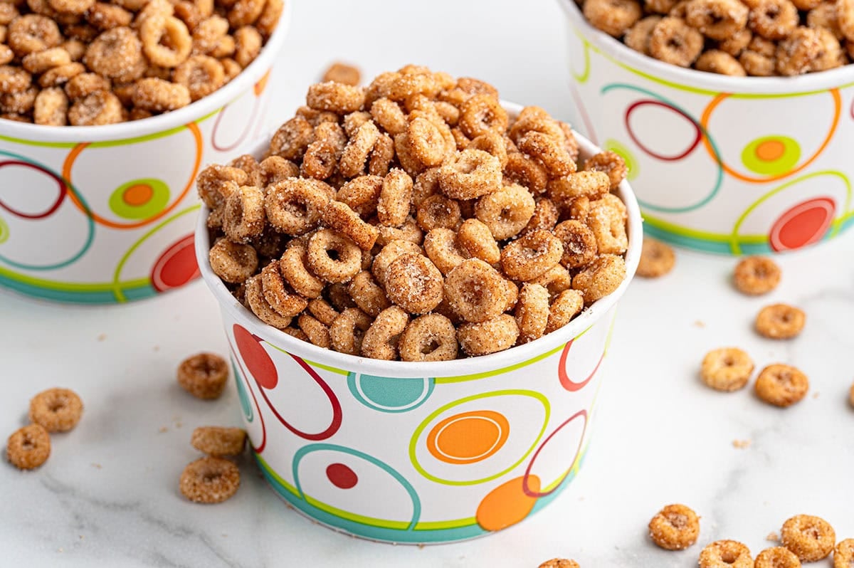 Sweet and crispy mini donut Cheerios served in a bright paper cup.