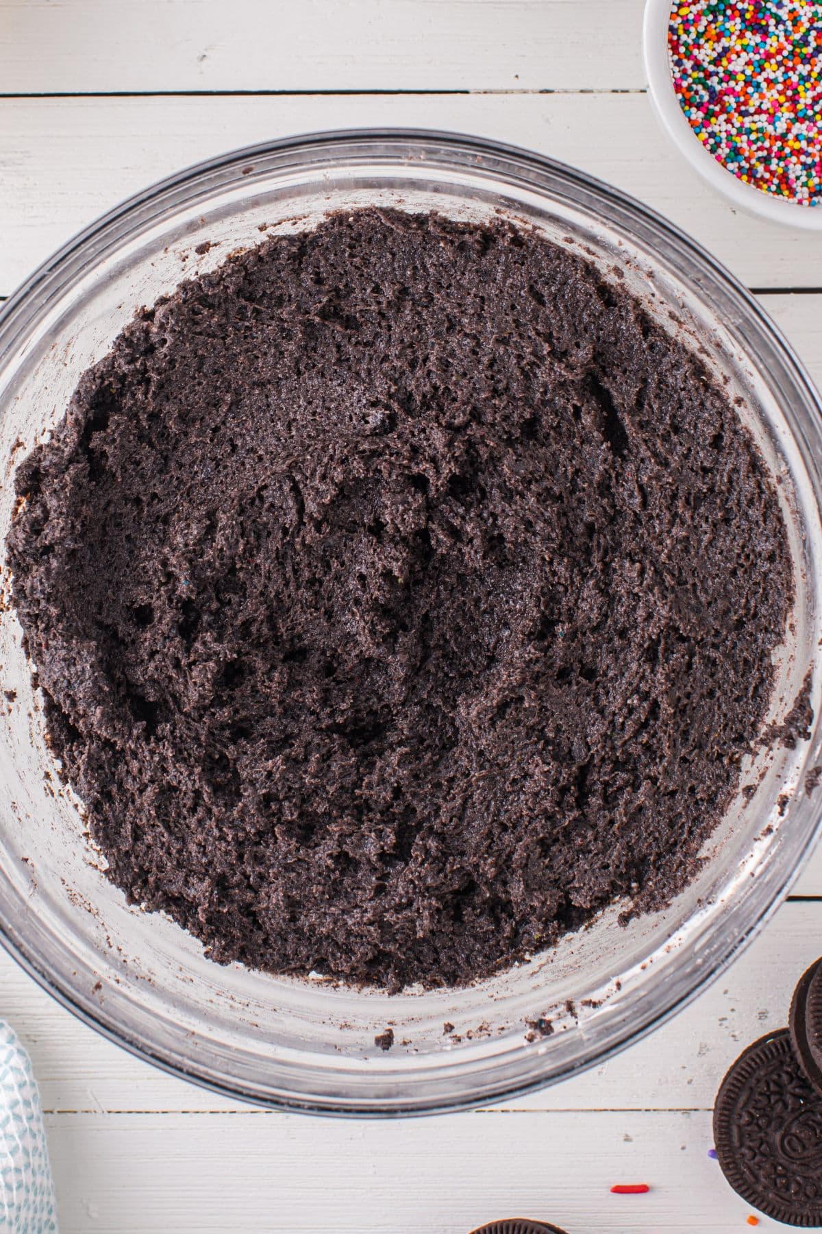 Blended and mixed Birthday Cake Oreo Balls ingredients in a glass bowl