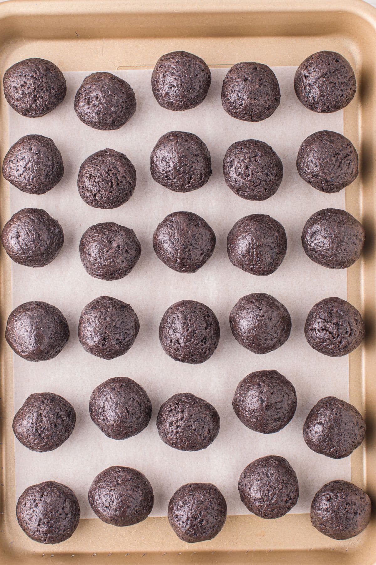 Half-done Birthday Cake Oreo balls on a baking sheet lined with parchment paper