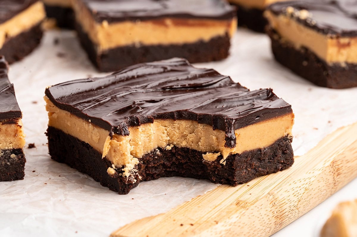 Close-up of a Buckeye brownie square with a fresh bite, revealing peanut butter and chocolate layers.