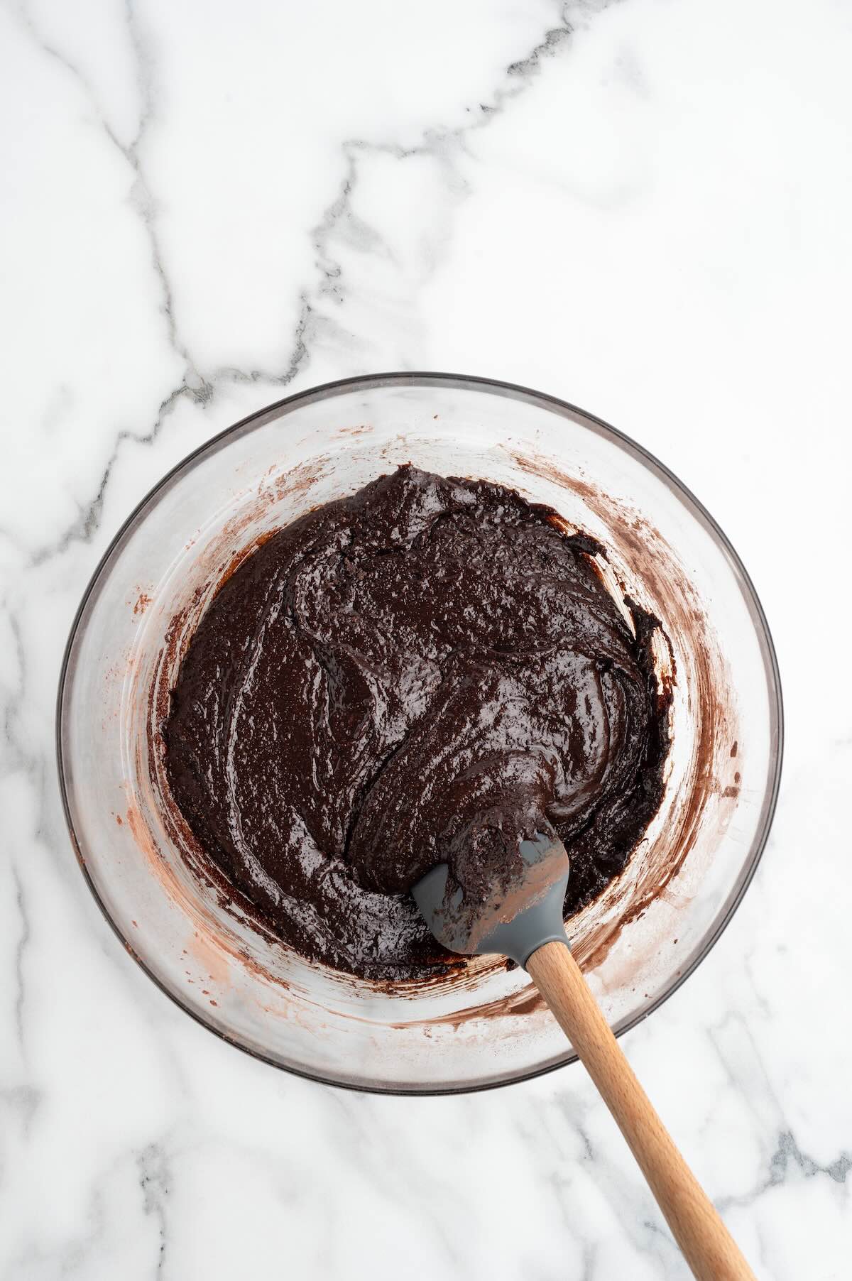 making brownie batter for Chocolate Mousse Brownies in a glass bowl