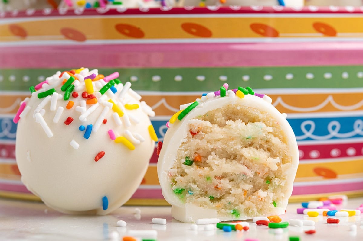 Fun and colorful dessert cheesecake balls with a creamy cheesecake center and white chocolate shell.
