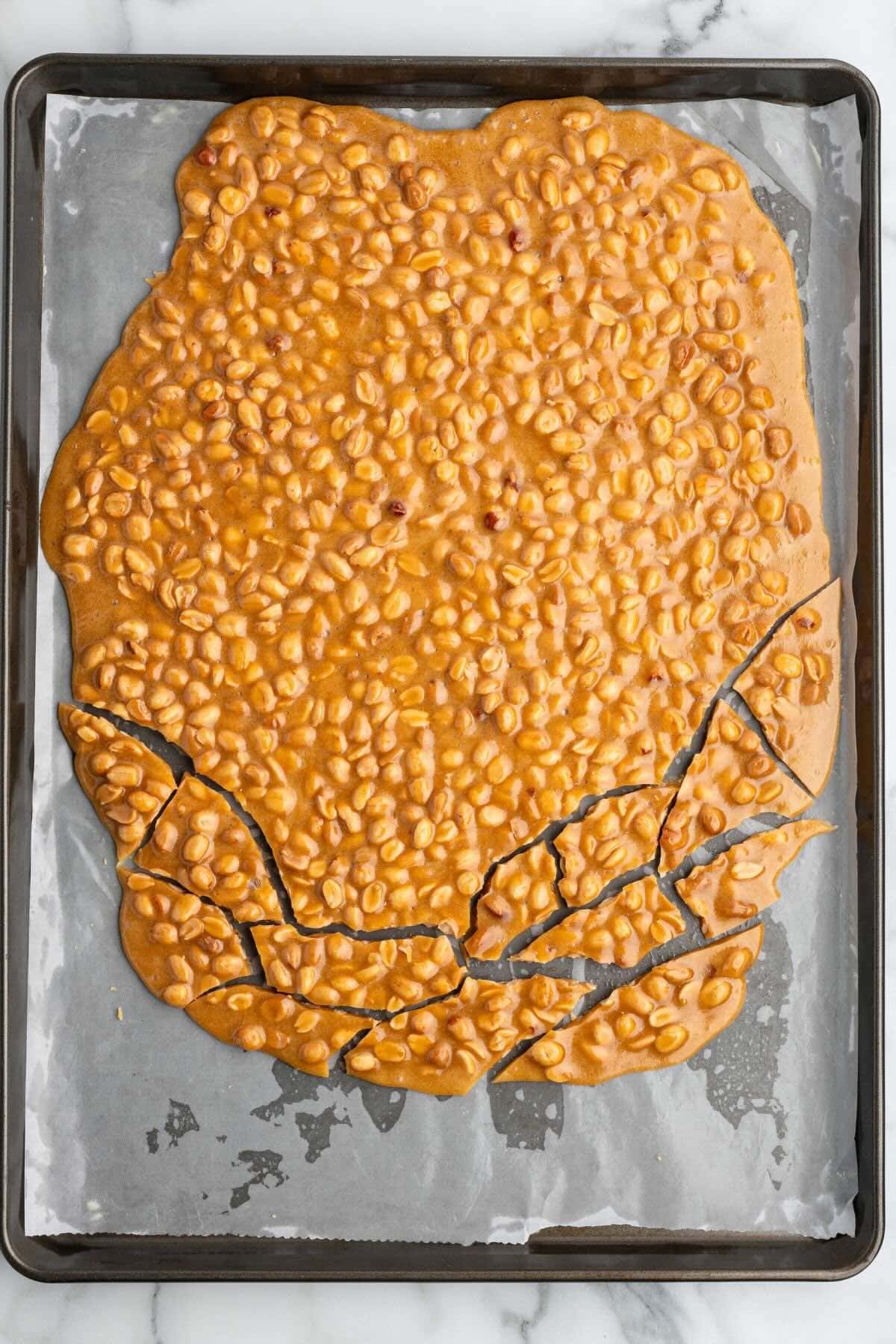 Breaking cooled peanut brittle into pieces