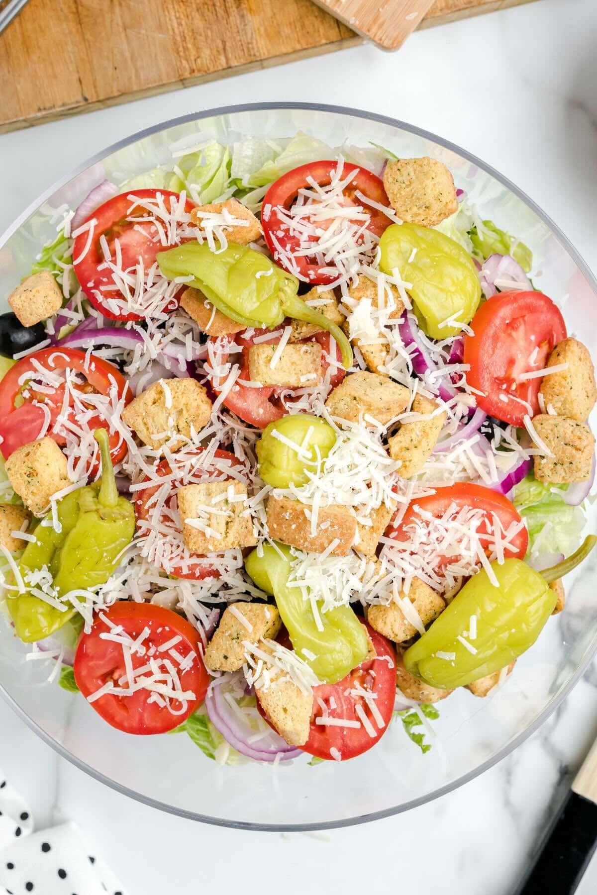 add salad ingredients into the bowl. 