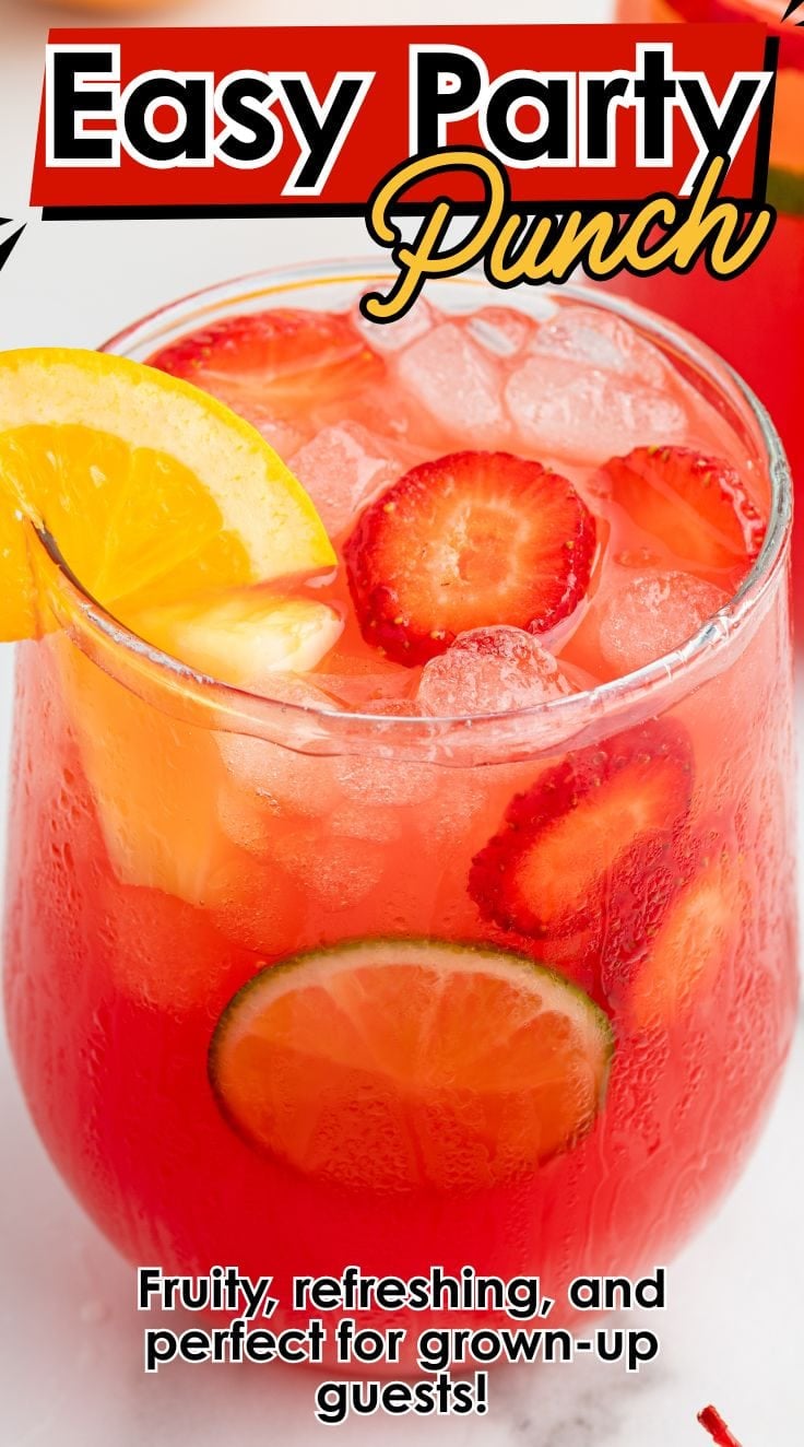 Vibrant party punch in a glass with fresh fruit slices