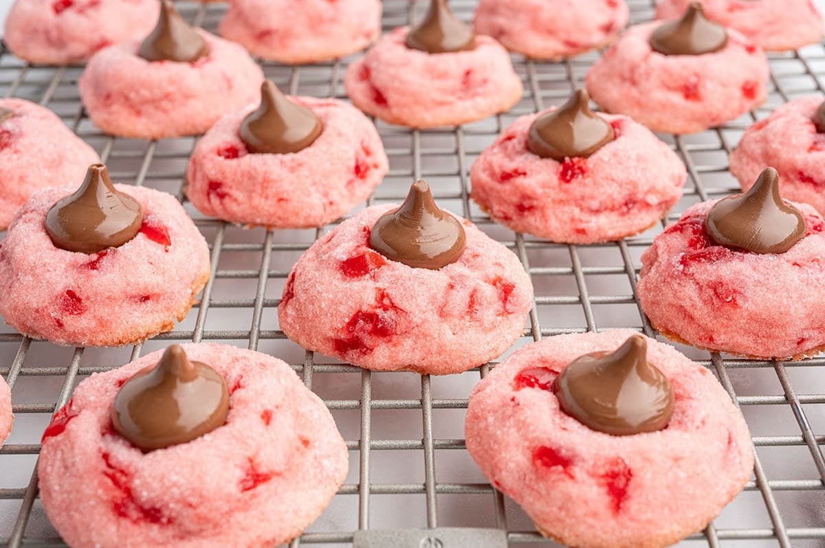 cherry kiss cookies lined on a cooling rack