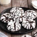 chocolate crinkle cookies on a black serving plate.