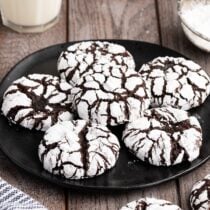 chocolate crinkle cookies on a black serving plate.