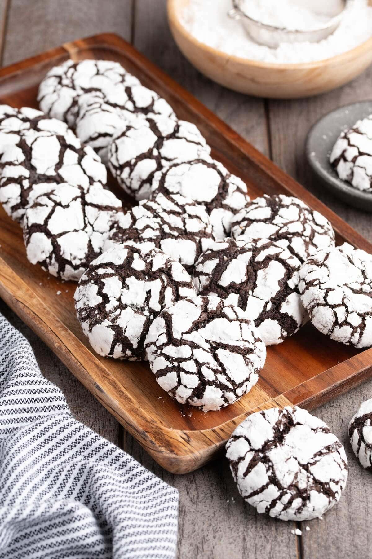 chocolate crinkle cookies served on top of wooden board. 