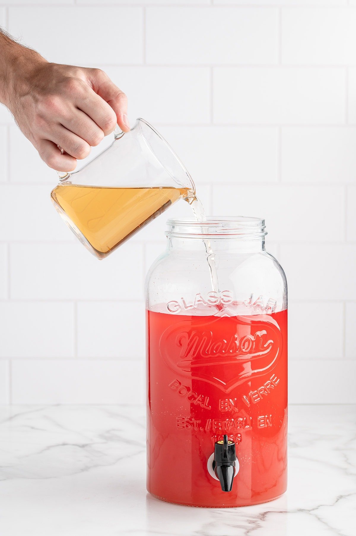 pour ingredients into drink dispenser