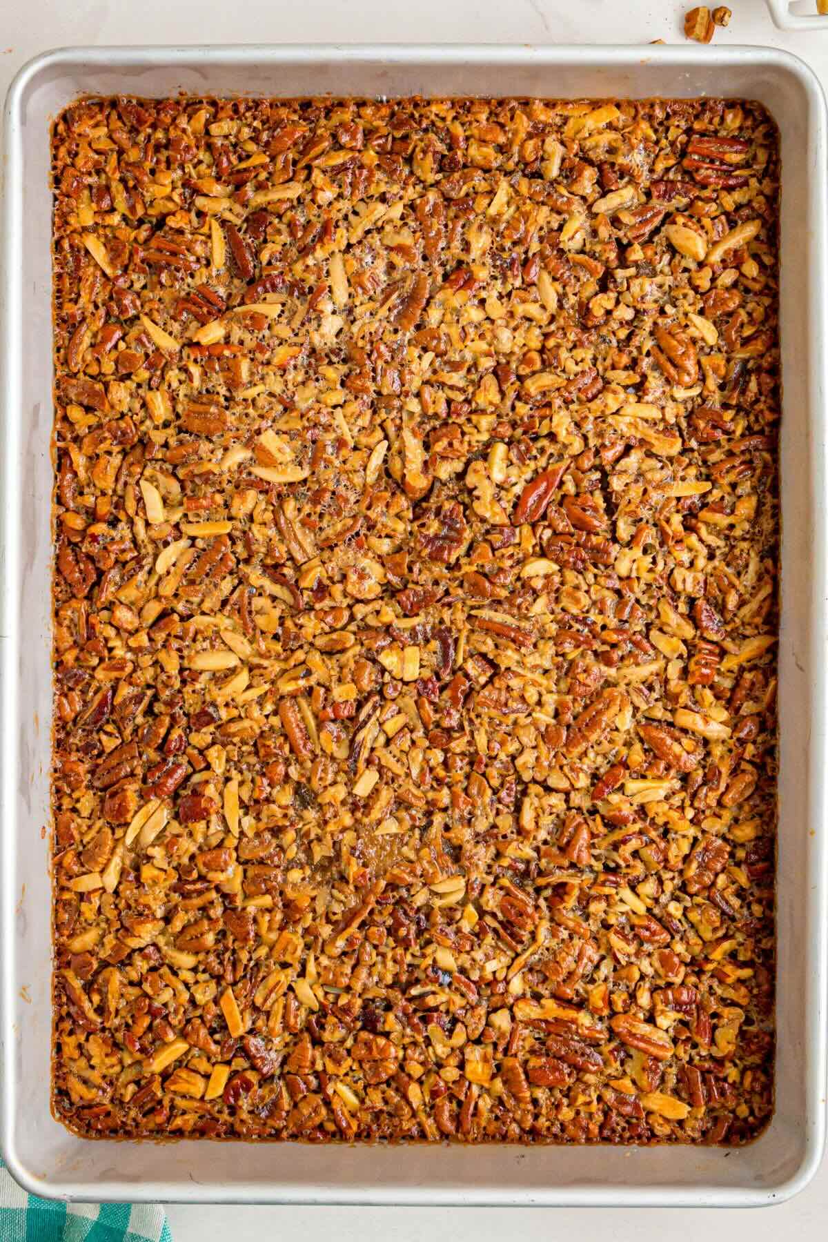 uncut baked pecan pie in baking pan. 