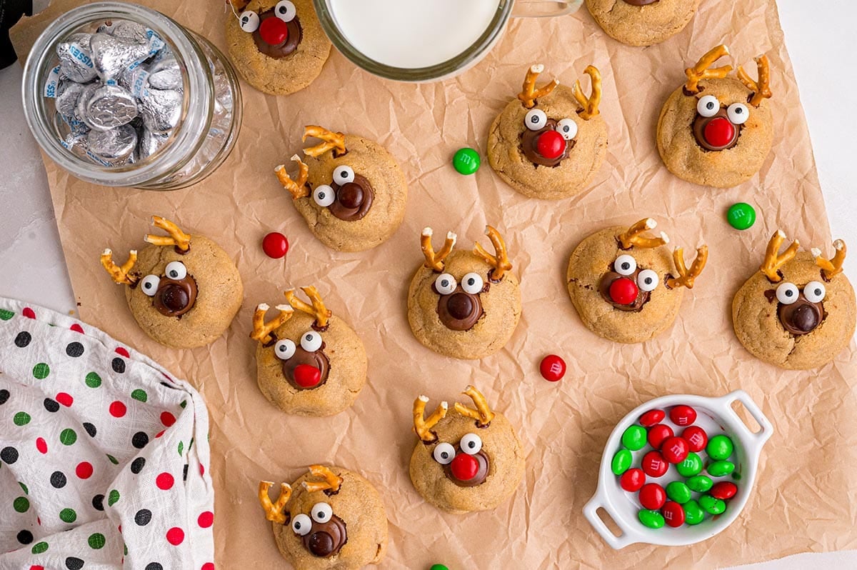 A batch of holiday reindeer cookies made from peanut butter blossoms features chocolate kisses and candy eyes.