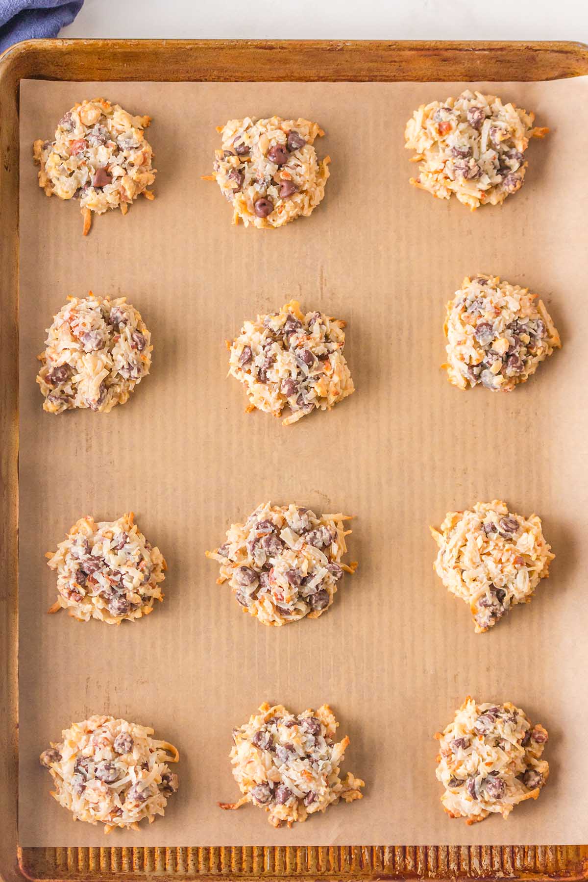 baked cookies lined up in baking sheet. 