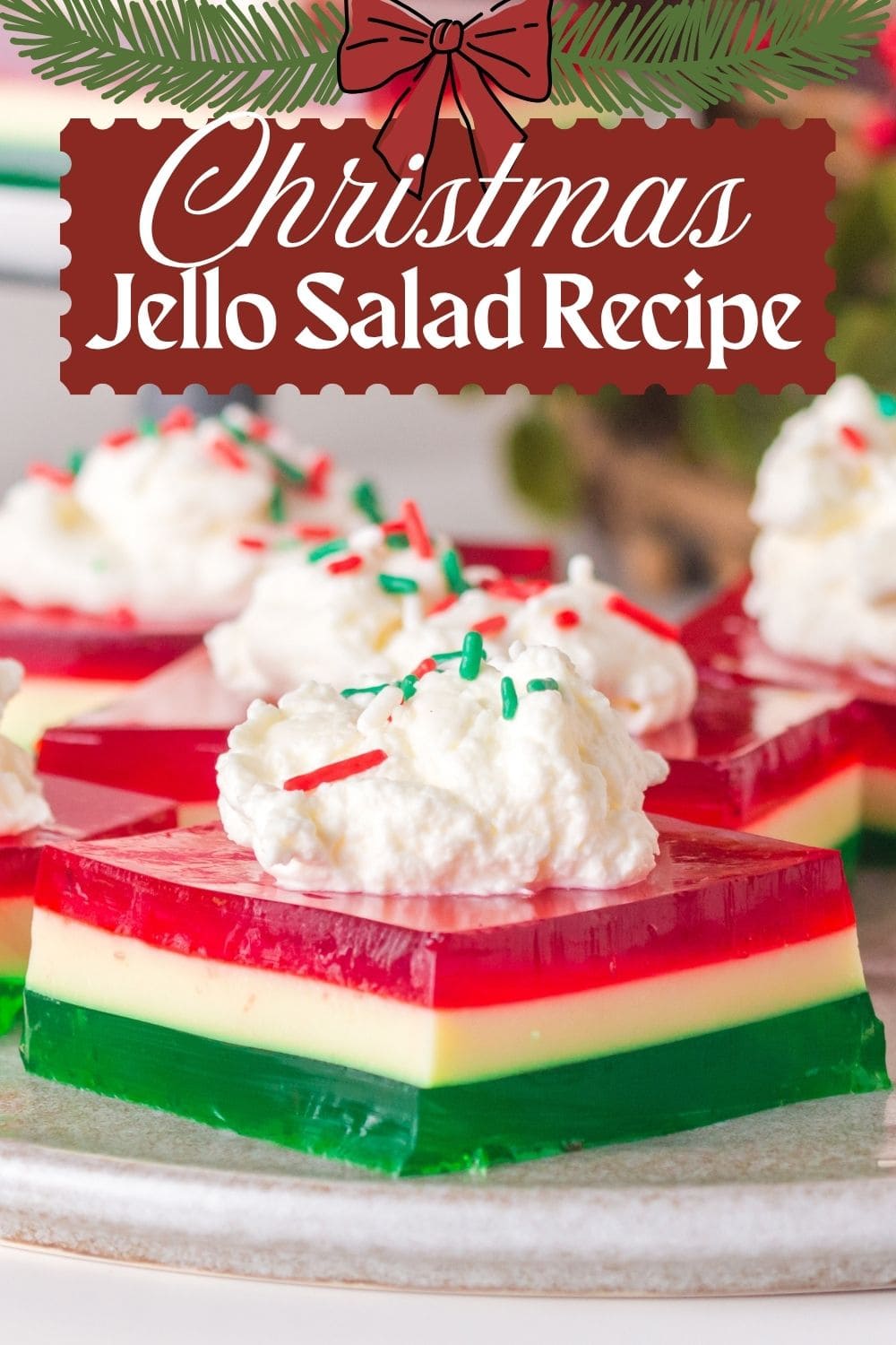 Layered Christmas ribbon Jello salad with red, white, and green gelatin layers cut into squares for a festive holiday dessert.